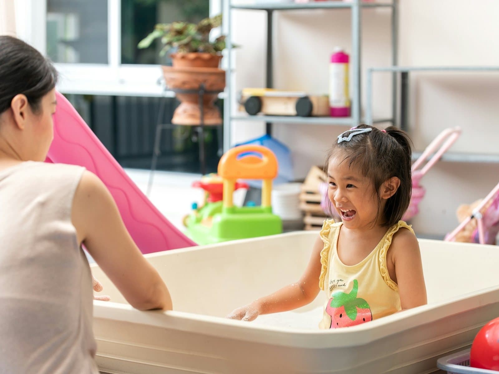 A smiling girl in a playroom